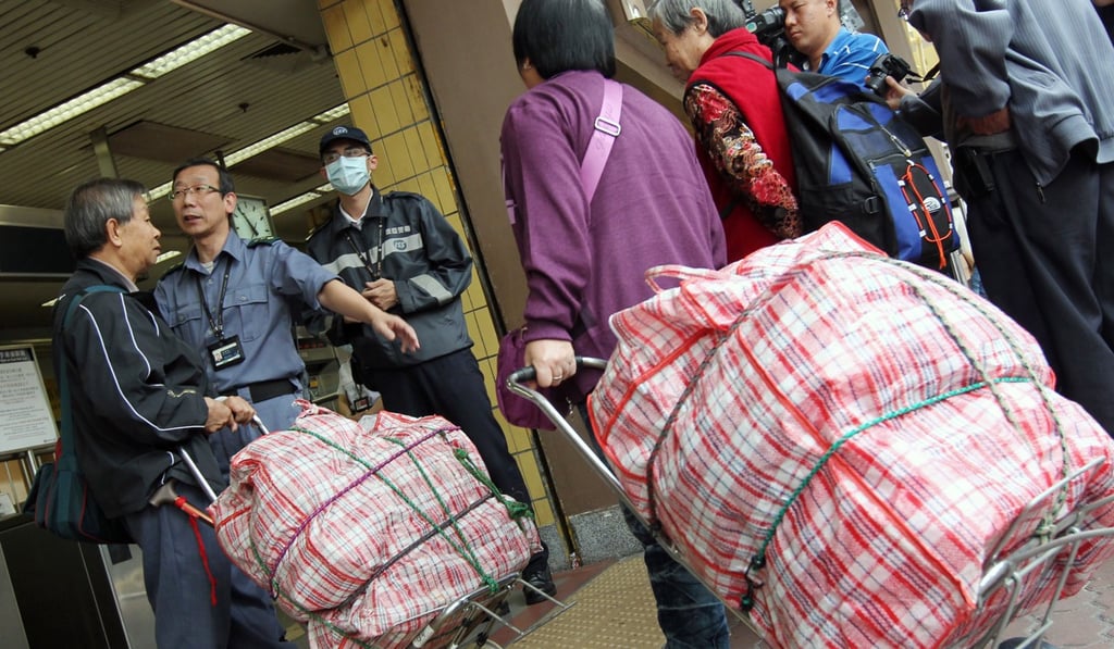 People with bulky luggage outside Sheung Shui MTR station. Photo: Nora Tam