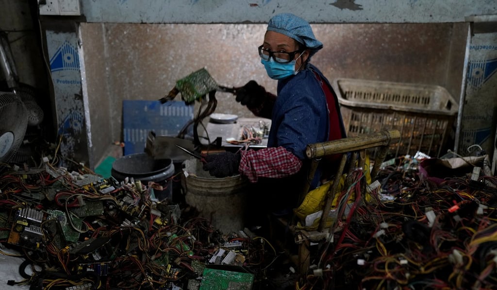 A worker dismantles electronic waste at the government-sponsored recycling park in the township of Guiyu, Guangdong Province, China, on January. Photo: Reuters