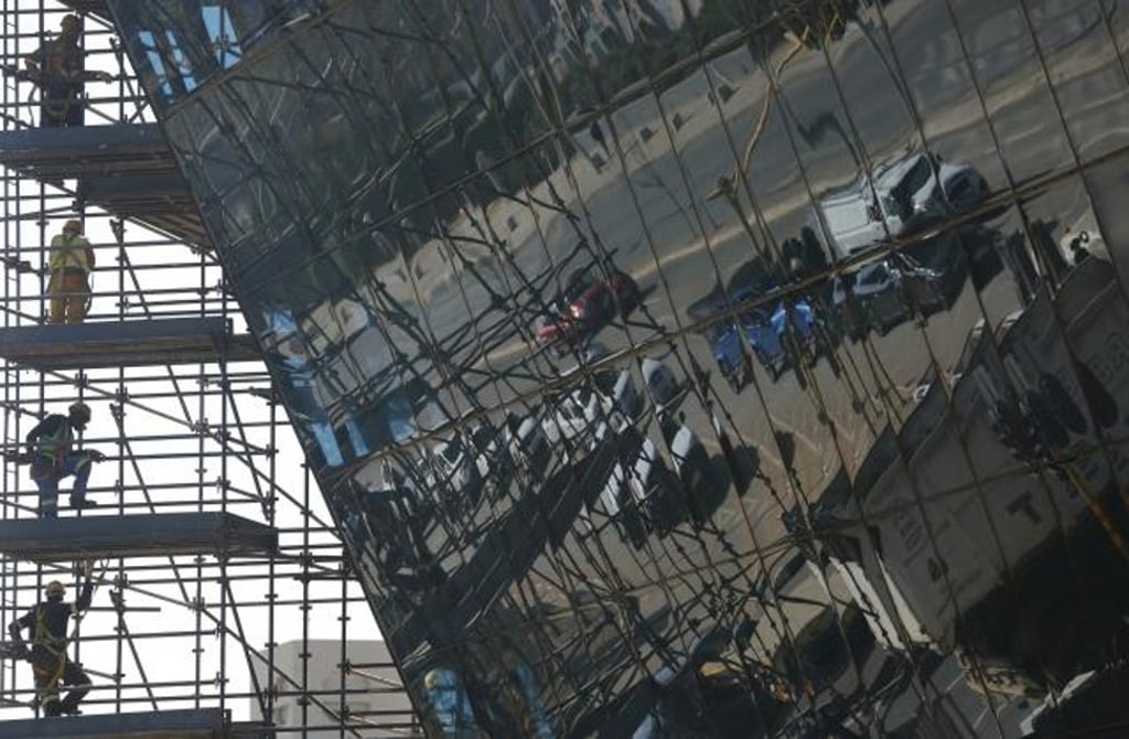 Vehicles pass along a road beside a new building under construction in Johannesburg. Photo: AP Vehicles pass along a road beside a new building under construction in Johannesburg. Photo: AP