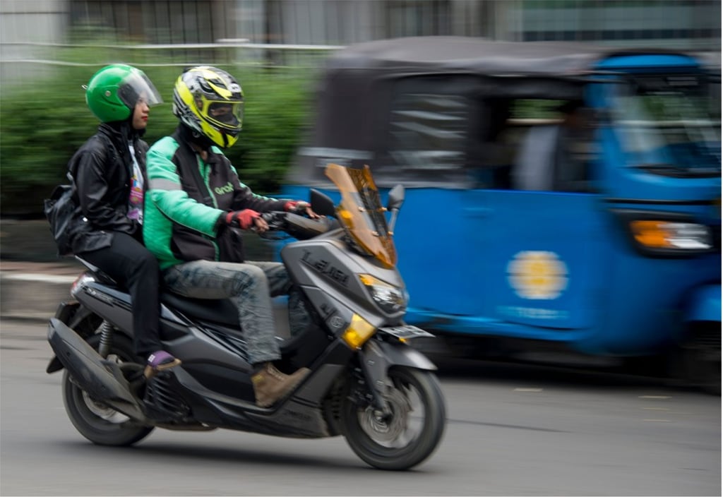 A Grab motorcycle-taxi transporting a passenger to her destination in Jakarta. Photo: AFP A Grab motorcycle-taxi transporting a passenger to her destination in Jakarta. Photo: AFP
