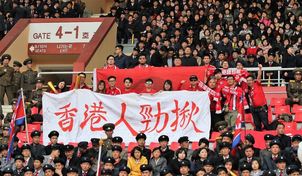 Hong Kong fans cheer on their team against North Korea. Hong Kong fans cheer on their team against North Korea.