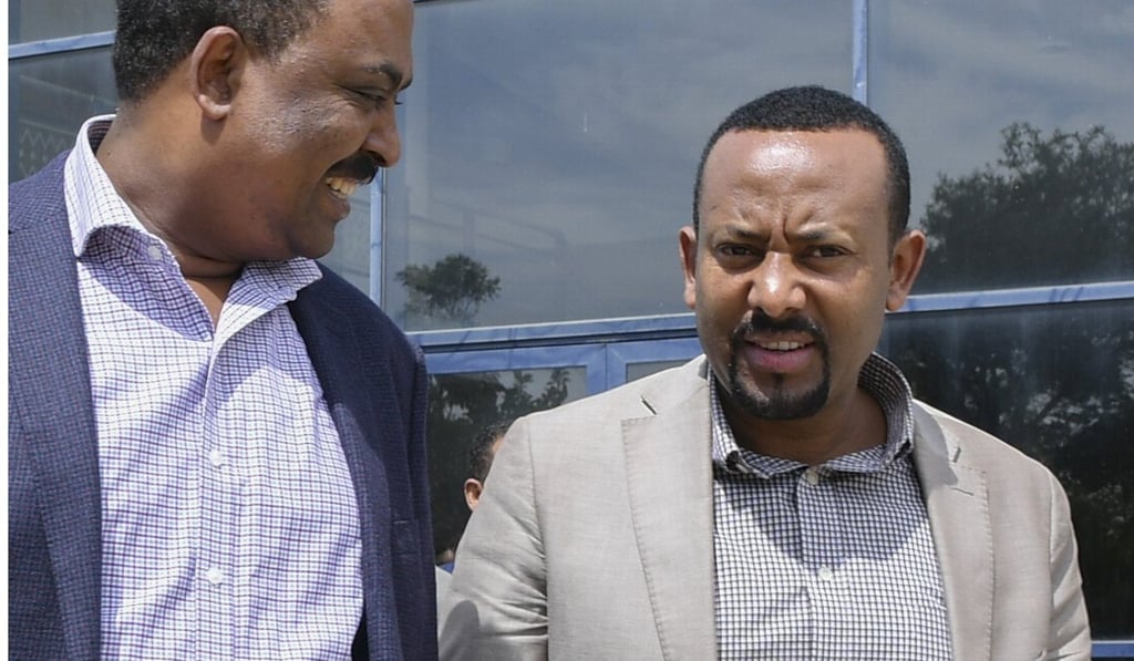 The leader of the Oromo Peoples Democratic Organisation (OPDO) Abiy Ahmed (right) talks with a colleague before a news conference in Aba Geda, Ethiopia, on November 2. Photo: EPA The leader of the Oromo Peoples Democratic Organisation (OPDO) Abiy Ahmed (right) talks with a colleague before a news conference in Aba Geda, Ethiopia, on November 2. Photo: EPA