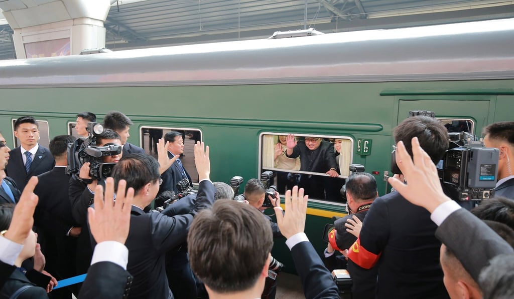 Kim Jong-un waves from his armoured train at Beijing railway station. Photo: Reuters/KCNA