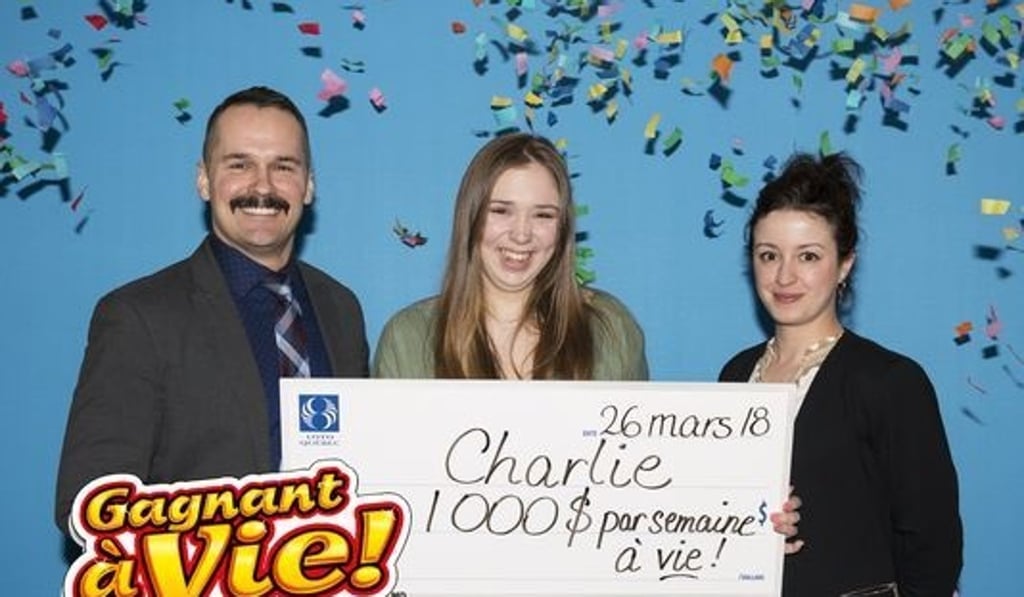 Charlie Lagarde (centre) at her symbolic cheque presentation in Montreal on Monday. Photo: Loto-Quebec Charlie Lagarde (centre) at her symbolic cheque presentation in Montreal on Monday. Photo: Loto-Quebec