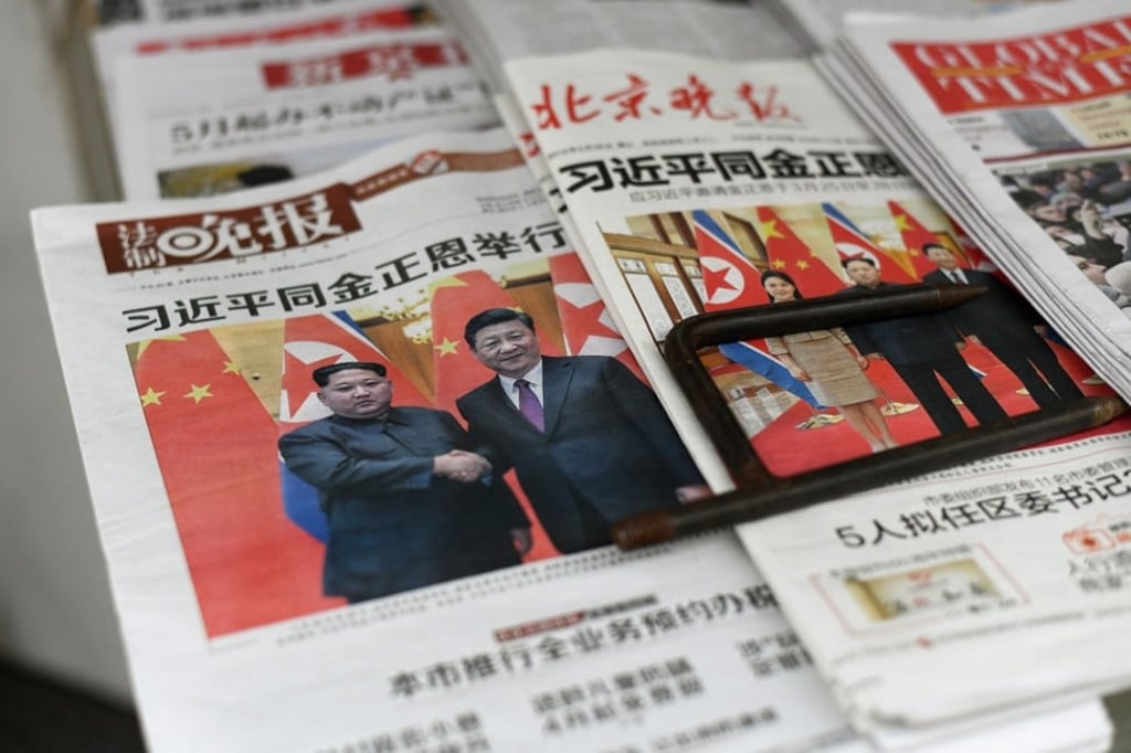 The front pages of Chinese evening newspapers show images of Xi Jinping with Kim Jong-un on Wednesday. Photo: AFP