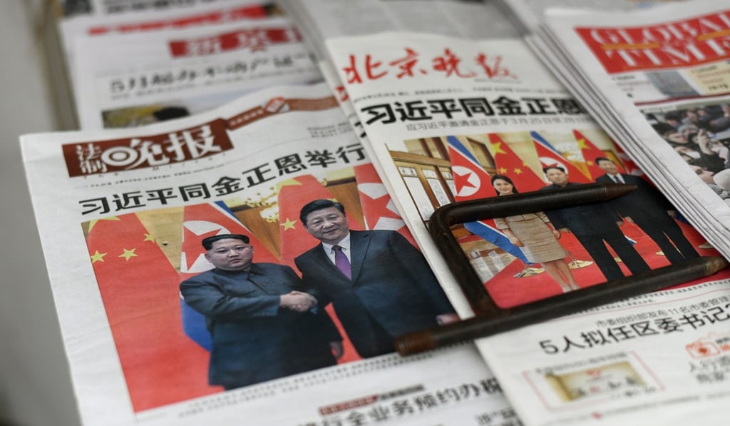 Chinese newspapers report on Kim Jong-un’s surprise meeting with President Xi Jinping. Photo: AFP