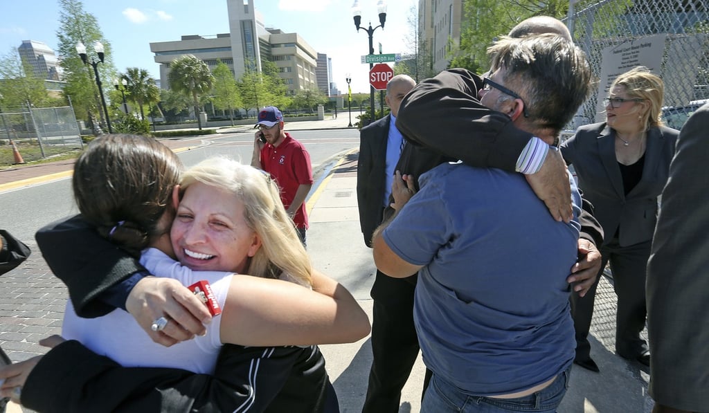 Susan Adieh (left), Salman’s cousin, and other members Salman’s family receive hugs from friends on Friday after her acquittal was announced. Photo: Orlando Sentinel via AP