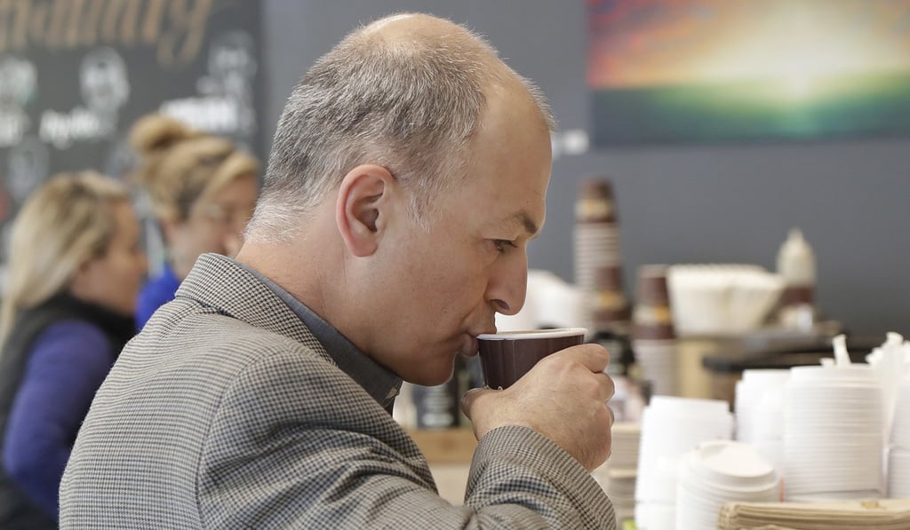 Afshin Afshar takes a sip from a coffee drink he bought at a Philz Coffee shop in San Francisco, on March 30, 2018. Photo: AP