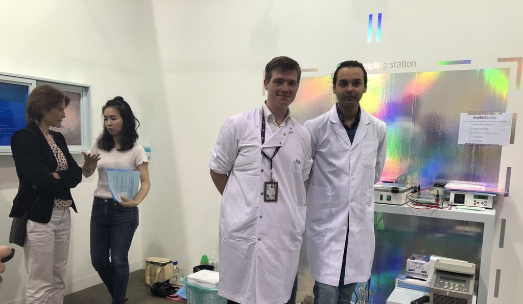 Karsten Berning and a colleague from City University of Hong Kong in front of their DNA collection point at AM Space’s booth during Art Basel Hong Kong 2018. Artist Wong Kit-yi can be seen talking to a visitor at the back. Photo: Enid Tsui