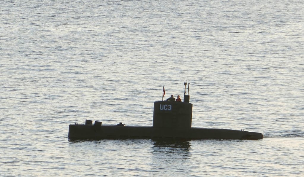 A man and a woman stand in the tower of the submarine UC3 Nautilus, on which Kim Wall is believed to have died. Photo: AFP