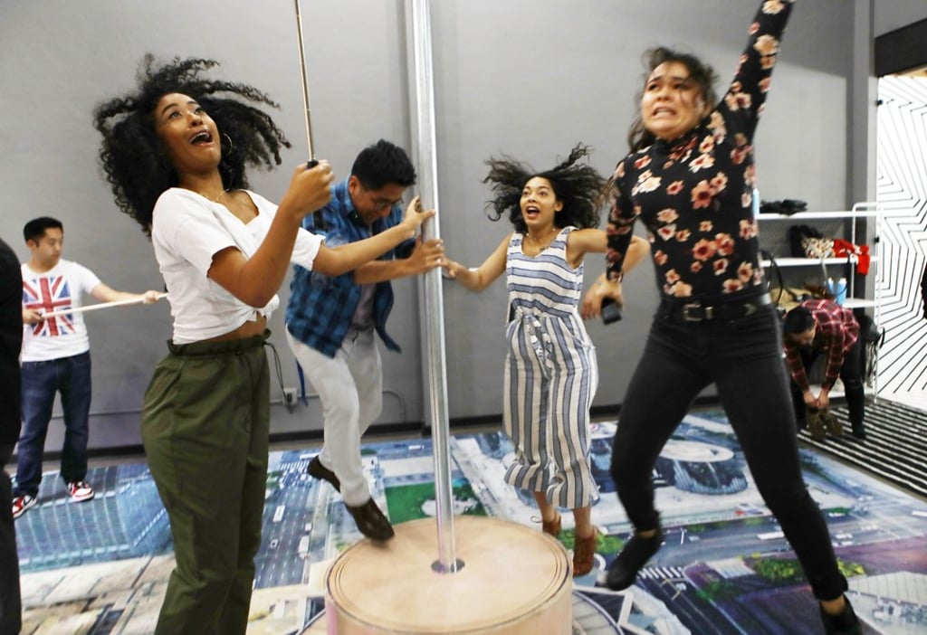 People jumping on a platform resembling the ground below Los Angeles’ Wilshire Grand Centre while taking a group selfie. Photo: AFP People jumping on a platform resembling the ground below Los Angeles’ Wilshire Grand Centre while taking a group selfie. Photo: AFP