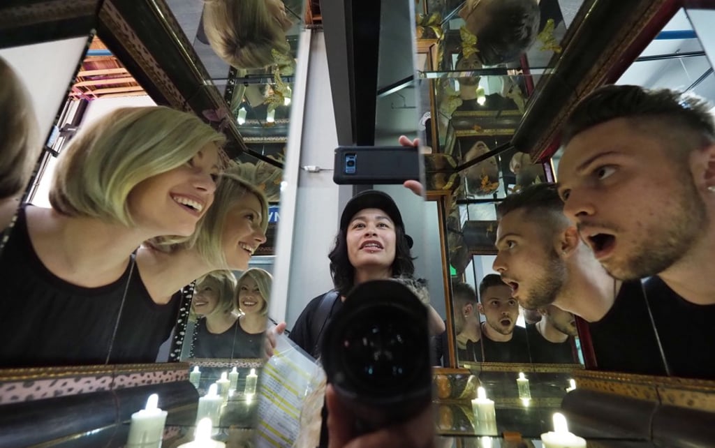 Visitors explore artist Matt Elson’s infinity box entitled ‘You And Me Together’. Photo: AFP Visitors explore artist Matt Elson’s infinity box entitled ‘You And Me Together’. Photo: AFP