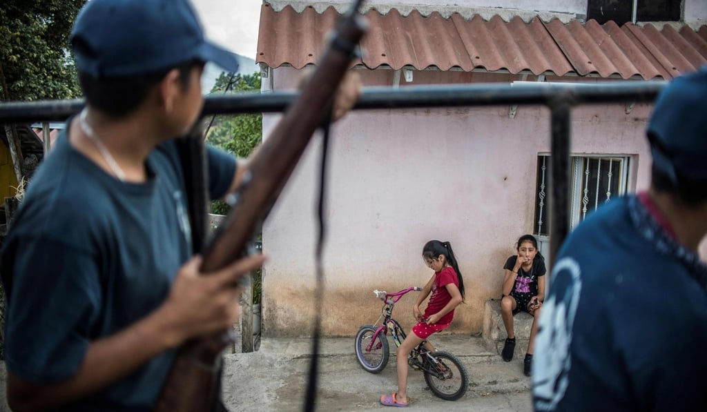 Guerrero community police members stand guard in Tlacotepec, Heliodoro Castillo municipality in Guerrero state on March 24. Bishop Salvador Rangel told reporters that he held several meetings with prominent drug traffickers in the state who agreed to stop attacking politicians. Photo: AFP