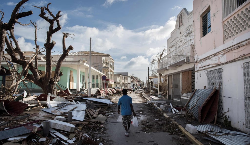 A man walks on a street covered in debris after hurricane Irma hurricane passed on the French island of Saint-Martin, near Marigot on September 8, 2017. Photo: AFP