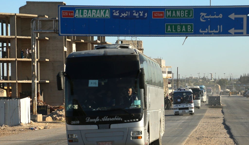 Buses carrying rebel fighters and their families from their former bastion in Douma, Syria, arrive at the Abu al-Zindeen checkpoint controlled by Turkish-backed rebel fighters on Wednesday. Photo: AFP Buses carrying rebel fighters and their families from their former bastion in Douma, Syria, arrive at the Abu al-Zindeen checkpoint controlled by Turkish-backed rebel fighters on Wednesday. Photo: AFP