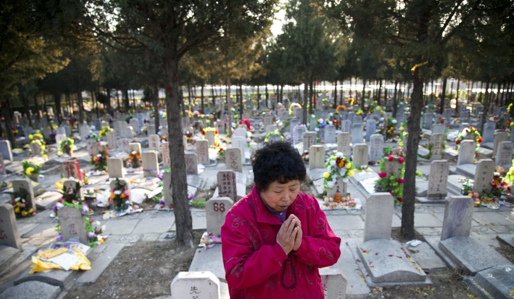 A Chinese woman prays at the grave of a loved one at the Babaoshan cemetery in Beijing to mark the Ching Ming festival.  Photo: AFP