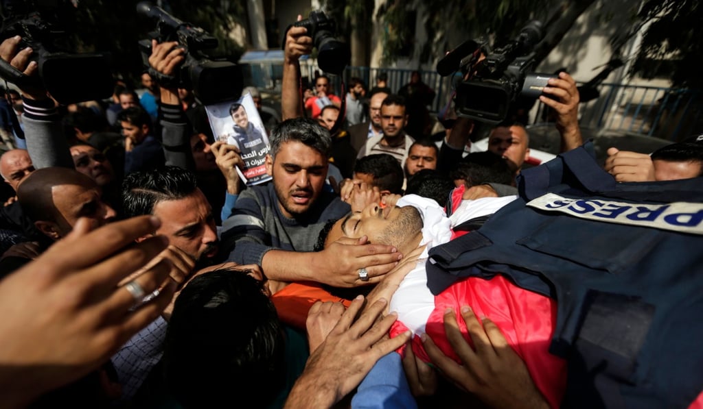 Mourners and journalists carry the body of Palestinian journalist Yasser Murtaja during his funeral in Gaza City on April 7. Photo: AFP