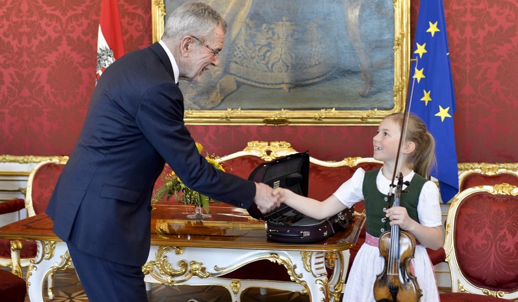 Seven-year-old Anna Caecilia Pfoess shakes hands with Austrian President Alexander Van der Bellen after playing a violin used by Mozart at the Chancellery in Vienna, Austria on Friday. Photo: AFP Seven-year-old Anna Caecilia Pfoess shakes hands with Austrian President Alexander Van der Bellen after playing a violin used by Mozart at the Chancellery in Vienna, Austria on Friday. Photo: AFP