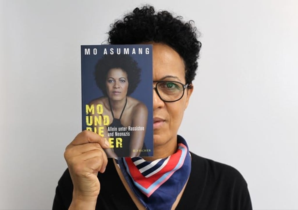 Asumang with a copy of her book, whose title translates as Mo and the Aryans. Photo: Roy Issa