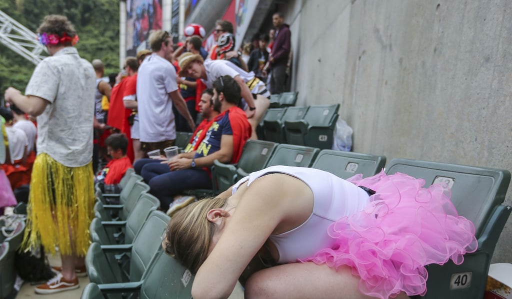 A fan is seen passed out during the second day of the Hong Kong Rugby Sevens. Photo: Xiaomei Chen