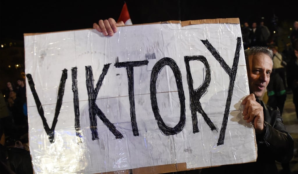 A supporter holds up a home-made placard reading 'Viktory' as Hungarian Prime Minister Viktor Orban (not pictured) celebrates from the podium. Photo: AFP