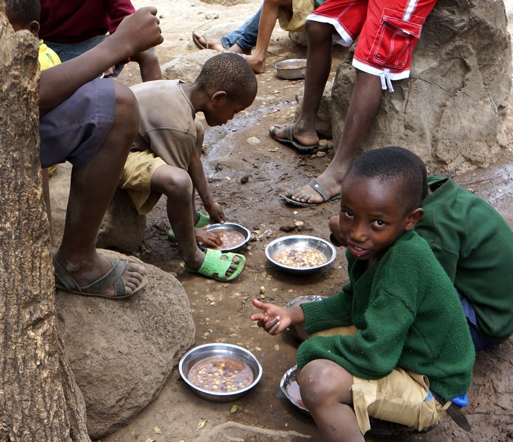 Students at a school in Arusha, Tanzania, eat their lunch. Most African nations have long been resistant to introducing GM technology for crop production, but recent reports say that may be changing. Photo: For The Washington Post by Sharon Schmickle