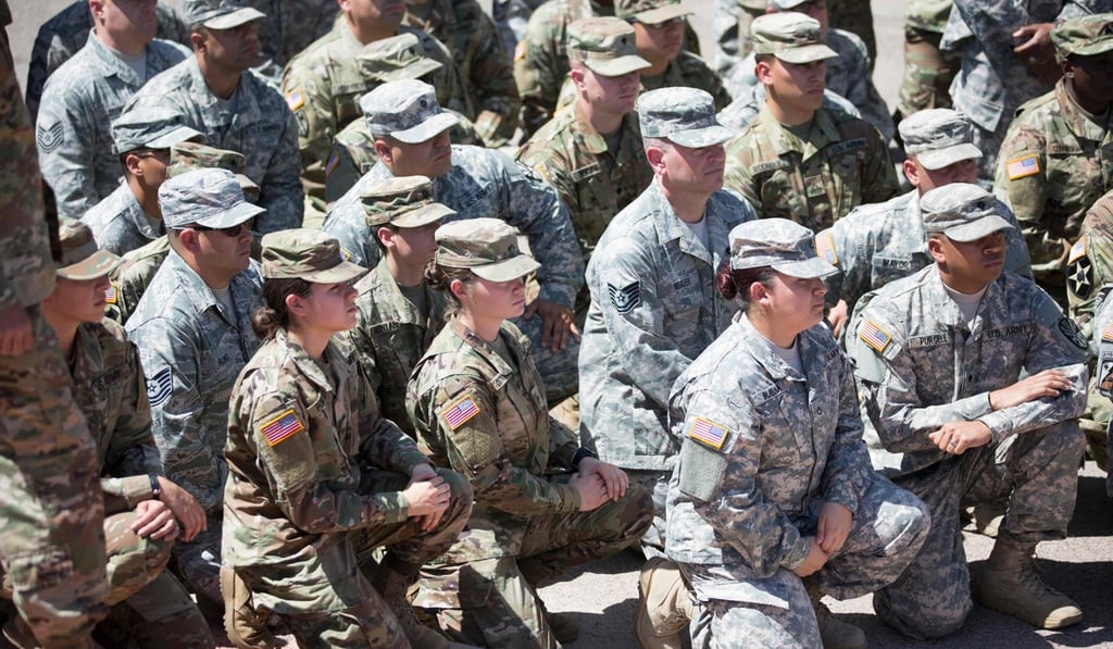 Members of the Arizona National Guard listening to Arizona Governor Doug Ducey on Monday at the Papago Park Military Reservation in Phoenix. Photo: AFP