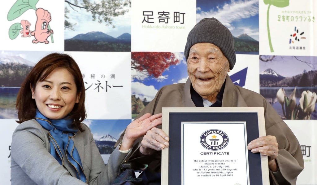 Japanese Masazo Nonaka, who was born 112 years and 259 days ago, receives a Guinness World Records certificate naming him the world's oldest man. Photo: Kyodo