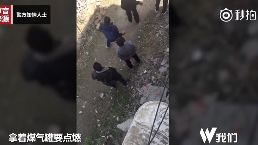 Several urban management officials were caught on camera throwing stones at people’s homes, though the exact details of the dispute were not clear. Photo: Weibo Several urban management officials were caught on camera throwing stones at people’s homes, though the exact details of the dispute were not clear. Photo: Weibo