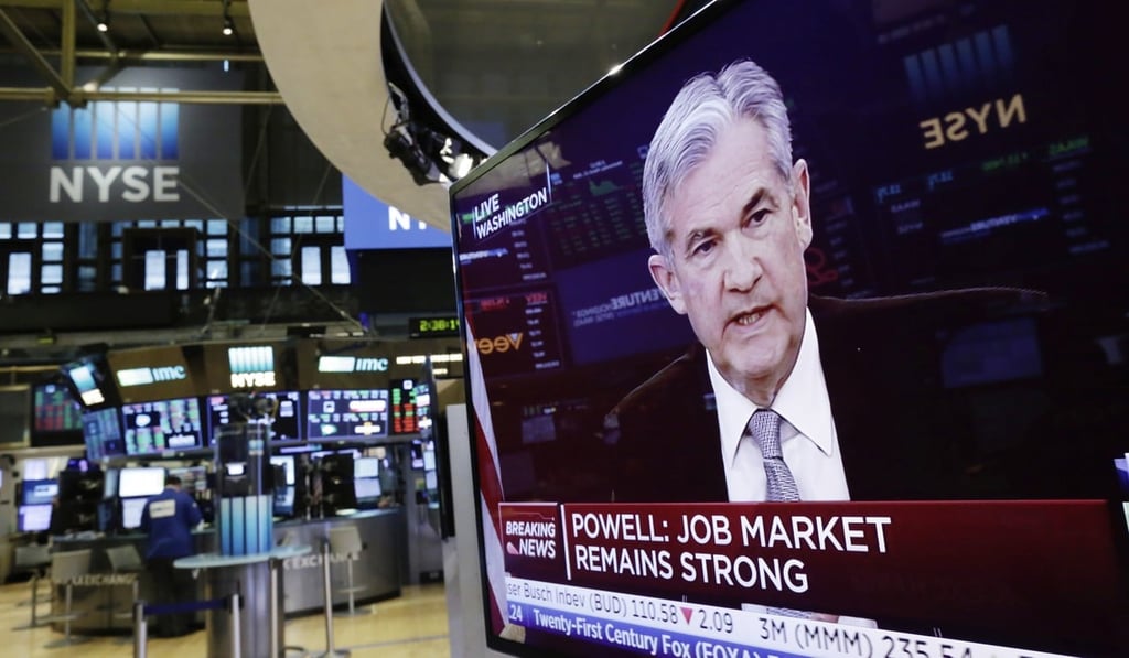 US Federal Reserve chairman Jerome Powell appears on a television screen on the floor of the New York Stock Exchange on March 21. The Fed has signalled that it will gradually raise its benchmark interest rate to reflect the stronger US economy. Photo: AP