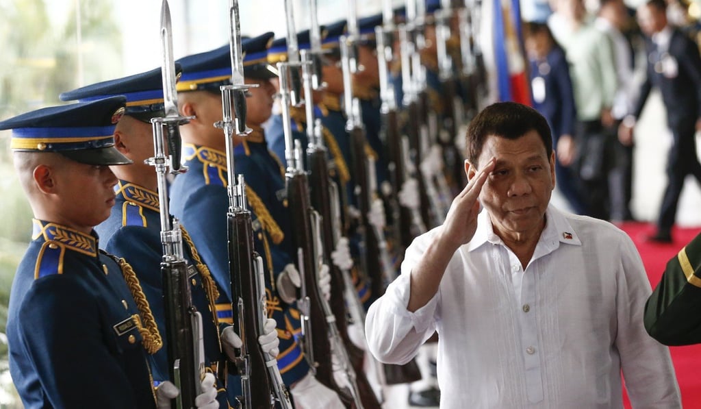 Philippine President Rodrigo Duterte salutes military honour guards during departure rites from the Ninoy Aquino International Airport in Manila before going to India to attend the Association of Southeast Asian Nations India Special Commemorative Summit. Photo: EPA