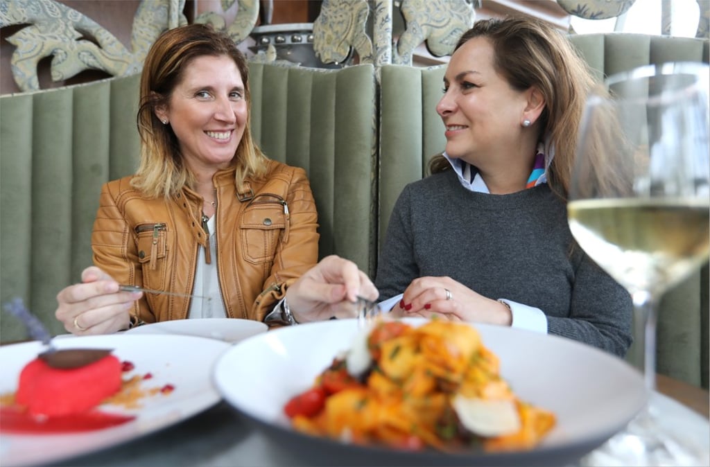 Spanish artist Cristina Moroño (left) and gallerist Adriana Álvarez-Nichol put on a brave face at Dear Lilly, with dishes Dear Lilly Heart (left) and puttanesca pappardelle. Photo: Edward Wong