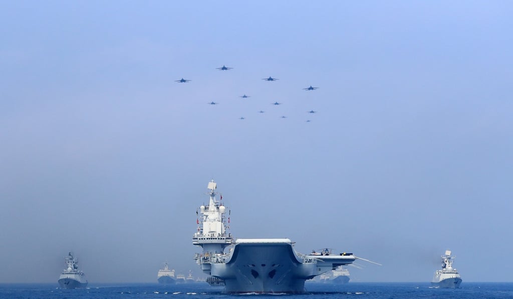 Chinese warships and fighter jets take part in a military display in the South China Sea on Thursday. Photo: Reuters