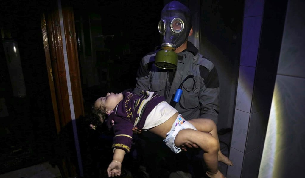 A rescue worker carries a young victim of a suspected chemical weapons attack in the rebel-held town of Douma, Syria. Photo: Syrian Civil Defense White Helmets via AP