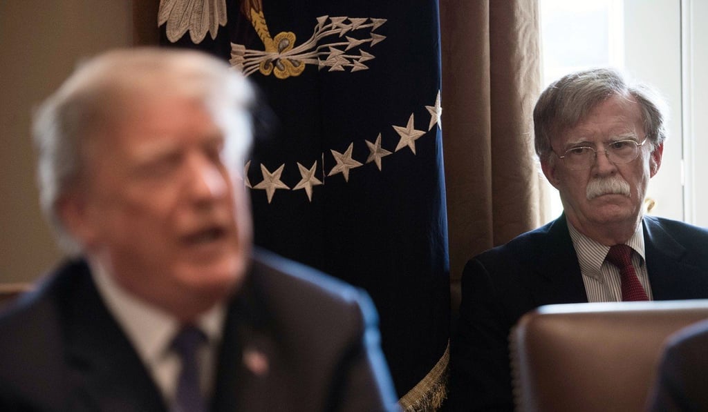 National Security Adviser John Bolton listens to US President Donald Trump. Bolton is clamouring for regime change in Iran. Photo: AFP