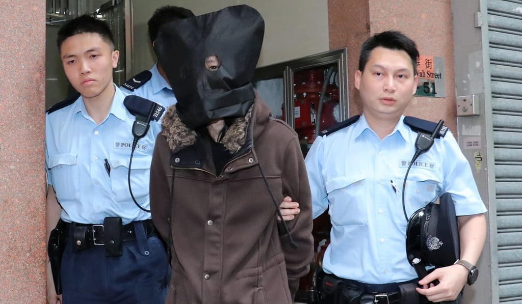 Police arrest a man suspected of throwing a dog off the top of a residential block. Photo: Handout