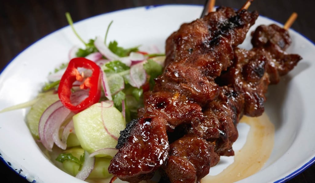 ChaChaWan’s grilled marinated pork skewers with cucumber and ginger salad.
