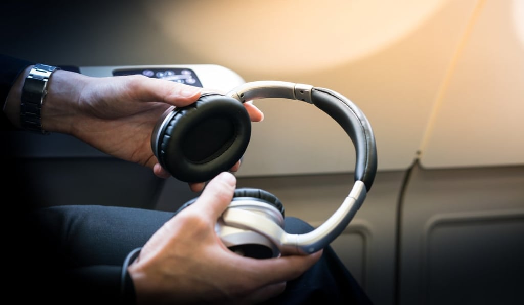 Noise-cancelling headphones will help you sleep on a long flight. Photo: Shutterstock