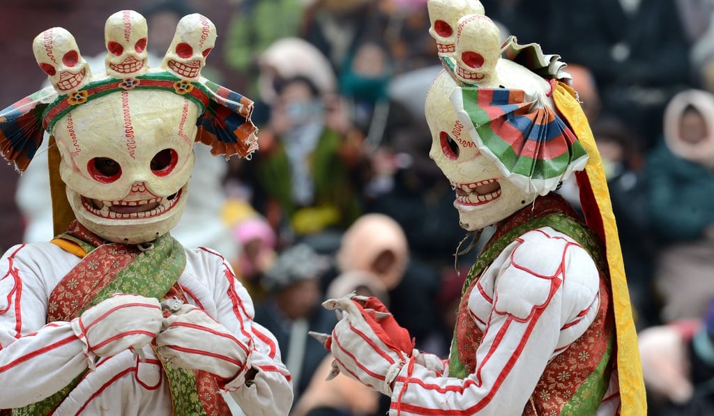 Two masked Tibetan Buddhist monks perform during a Cham dance ritual. Photo: Xinhua/Chogo
