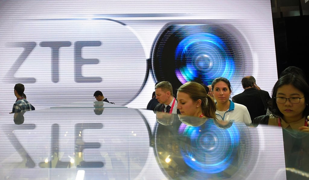 Visitors test smartphones at ZTE's stand during the Mobile World Congress in Barcelona. Photo: AFP