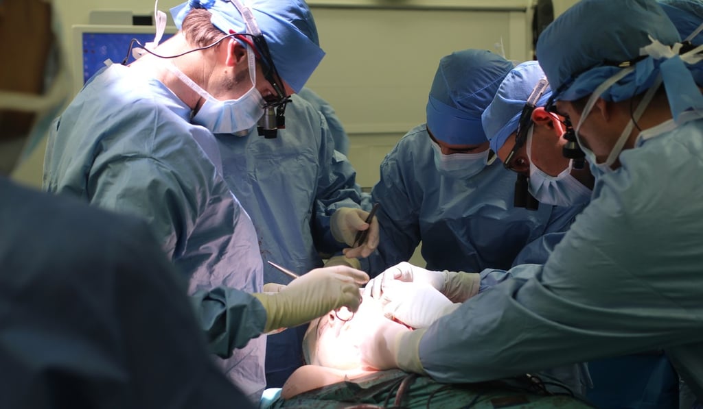 In this undated handout photo provided on Tuesday, surgeons perform a face transplant on Jerome Hamon. Photo: AP
