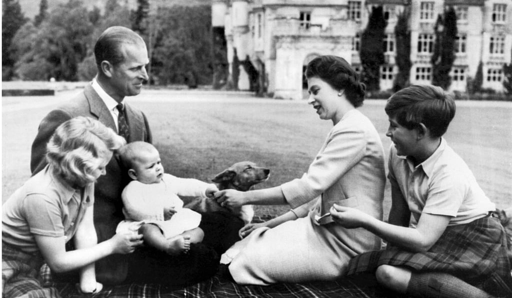 In a file picture taken on September 8, 1960 Britain's Queen Elizabeth and Prince Philip sit at Balmoral with their children Princess Anne (left), Prince Charles (right) and the newborn Prince Andrew playing with a corgi. Photo: Agence France-Presse