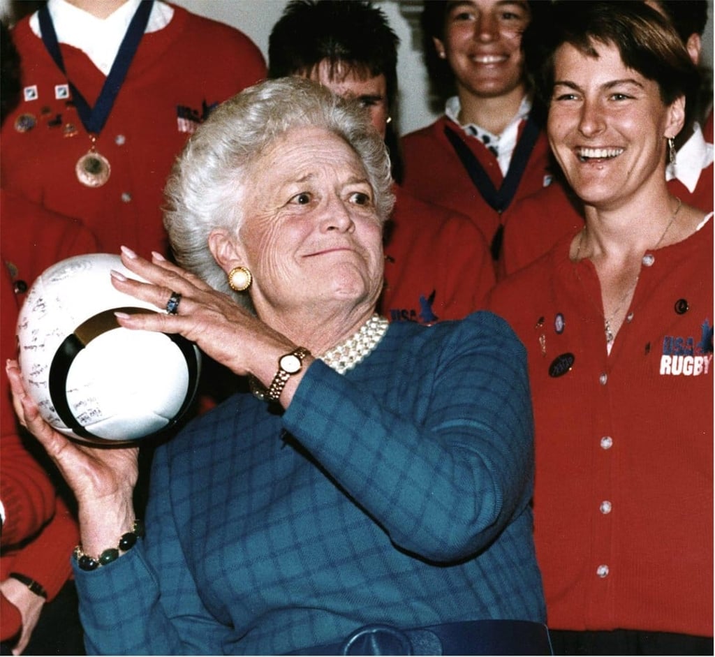Barbara Bush, then the US first lady, prepares to throw a rugby ball in Washington in February 1992 after receiving it from Mary Sullivan (right), captain of the US national women's team. Bush was presenting them with the Team Spirit Award for winning that year’s Women’s Rugby World Cup. Photo: AFP Barbara Bush, then the US first lady, prepares to throw a rugby ball in Washington in February 1992 after receiving it from Mary Sullivan (right), captain of the US national women's team. Bush was presenting them with the Team Spirit Award for winning that year’s Women’s Rugby World Cup. Photo: AFP