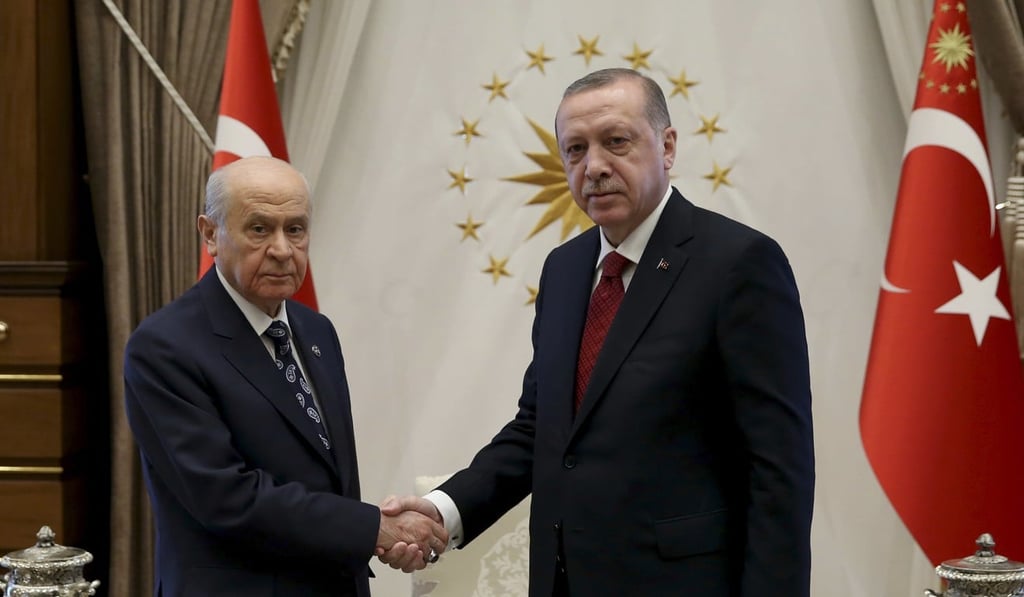 Turkish President Recep Tayyip Erdogan, right, shakes hands with Devlet Bahceli, leader of the Nationalist Movement Party and his political ally, before their meeting at the presidential palace in Ankara, Turkey, on Wednesday. Photo: AP