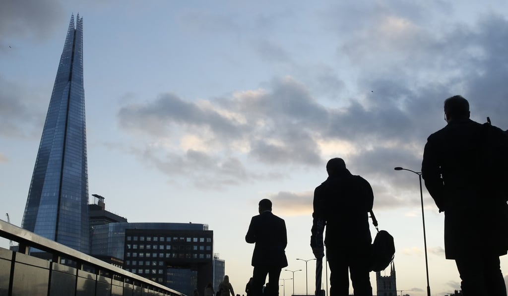 Workers pass the Shard, Europe’s tallest building, as they cross London Bridge in the City of London in this file photo. Photo: Reuters