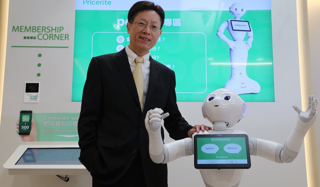 Pricerite CEO James Leung with Pepper, a customer service robot who speaks Cantonese. Photo: Edward Wong