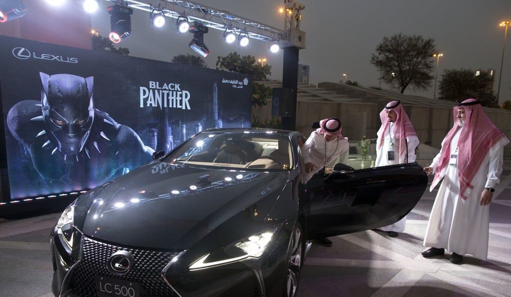 A visitor checks out a Lexus car, similar to a one used in the film Black Panther, on display outside an invitation-only screening of the film at the King Abdullah Financial District Theatre in Riyadh. Photo: AP