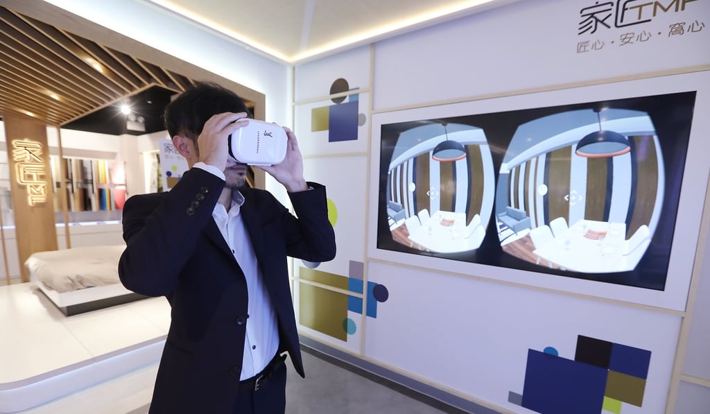 A staff member tests out a new virtual reality headset at Pricerite’s flagship store in Mong Kok. Photo: Edward Wong