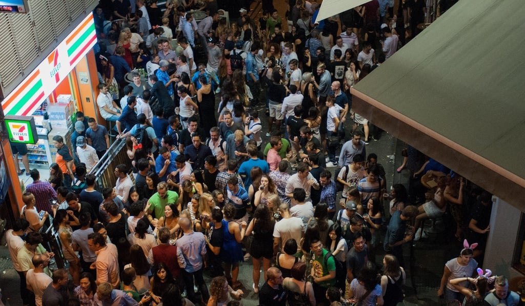 Late-night revellers in Lan Kwai Fong in Central congregate outside a 7-Eleven convenience store.