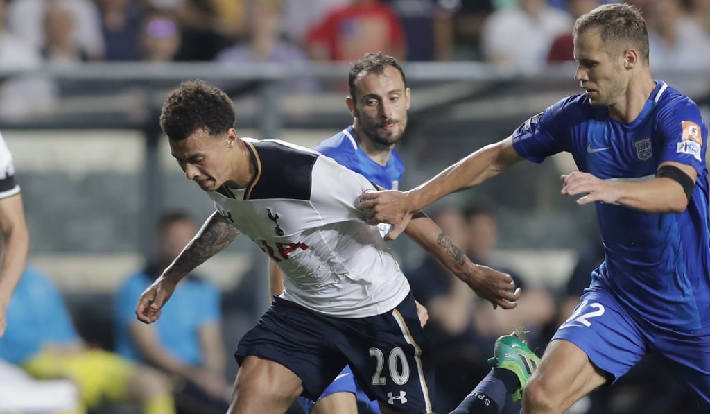Kitchee's Krisztian Vadocz grapples with Tottenham's Dele Alli in Hong Kong last year. Photo: AP